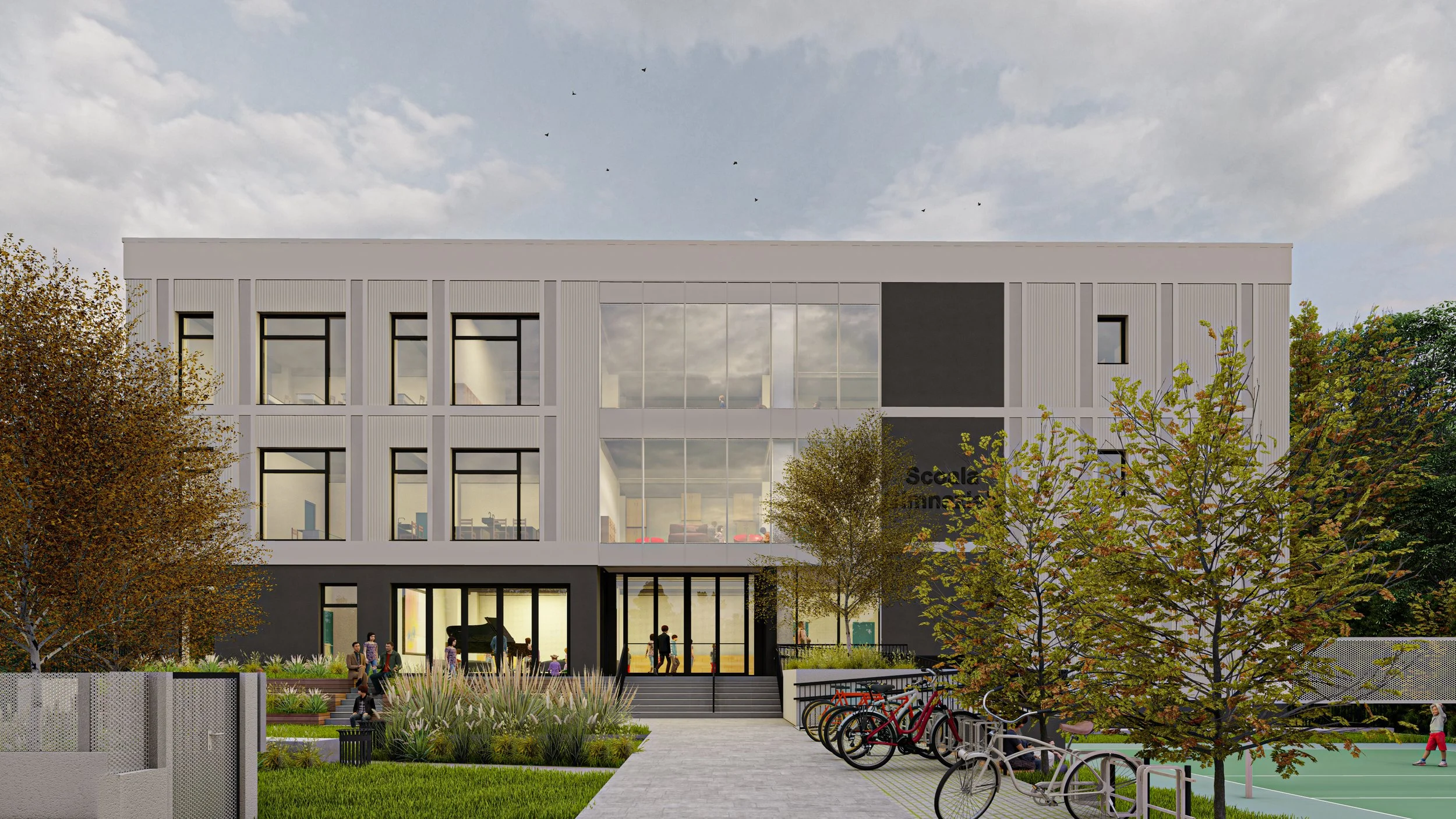 A modern multi-story school building with garage doors and large glass windows, surrounded by trees and a bike rack, with children and people in front of it.