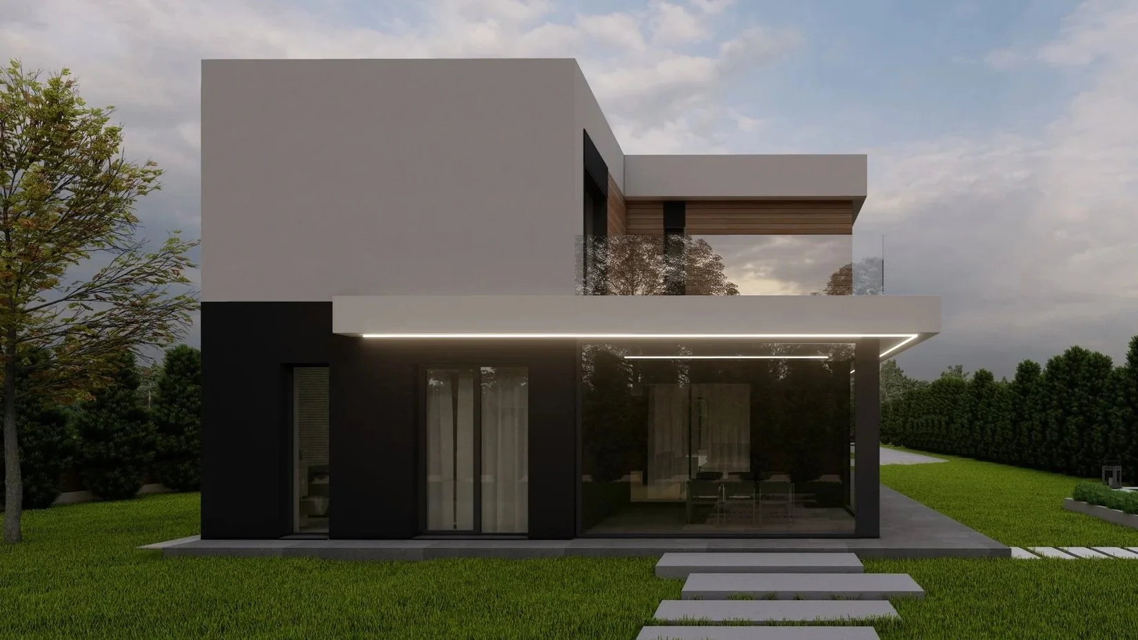 Modern two-story house with black and white exterior, large glass sliding doors, a flat roof, and an outdoor patio, surrounded by a green lawn and trees in the background, during cloudy weather.