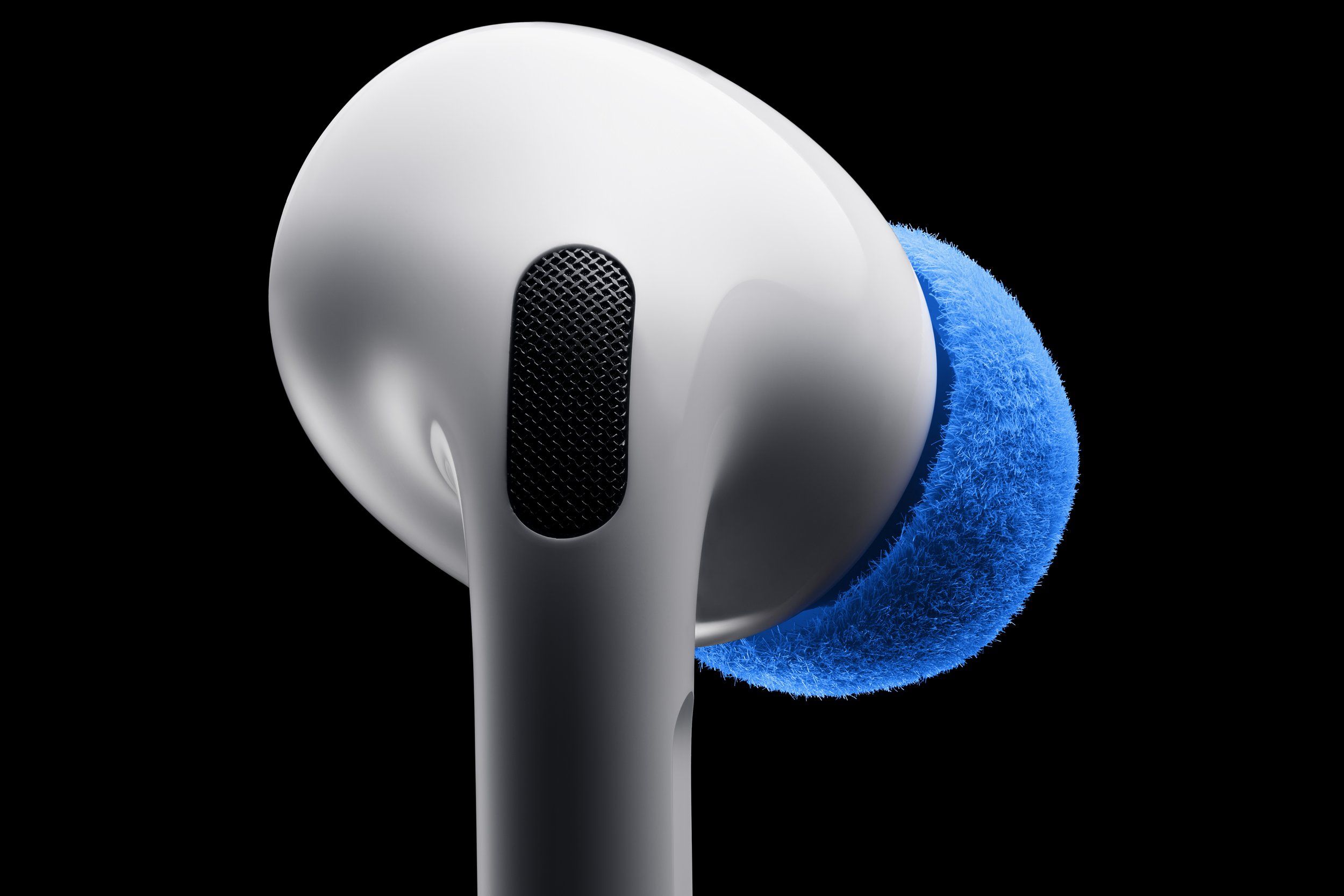 Close-up of an Apple AirPod with a blue ear tip against a black background.