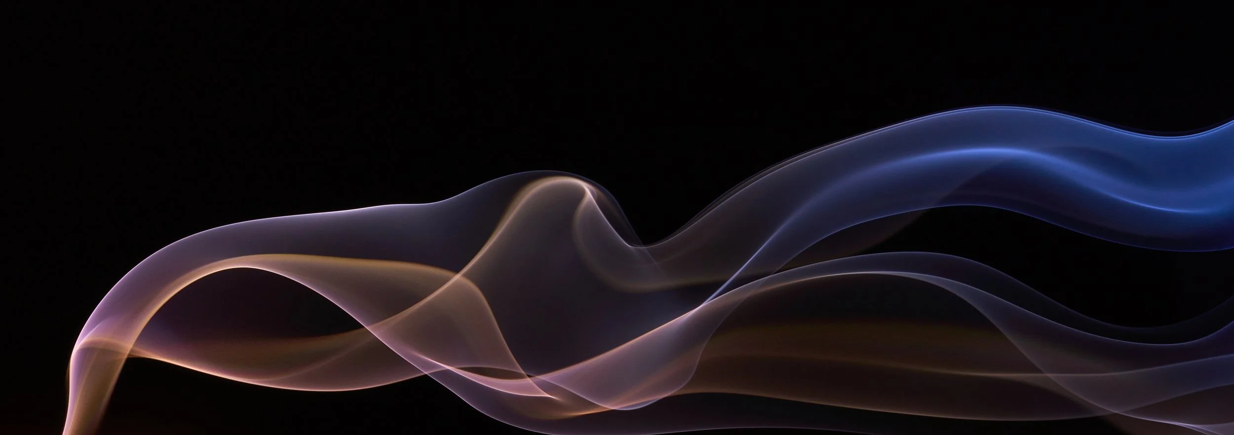 Abstract wisps of colorful smoke against a black background, with shades of purple, blue, and pink.