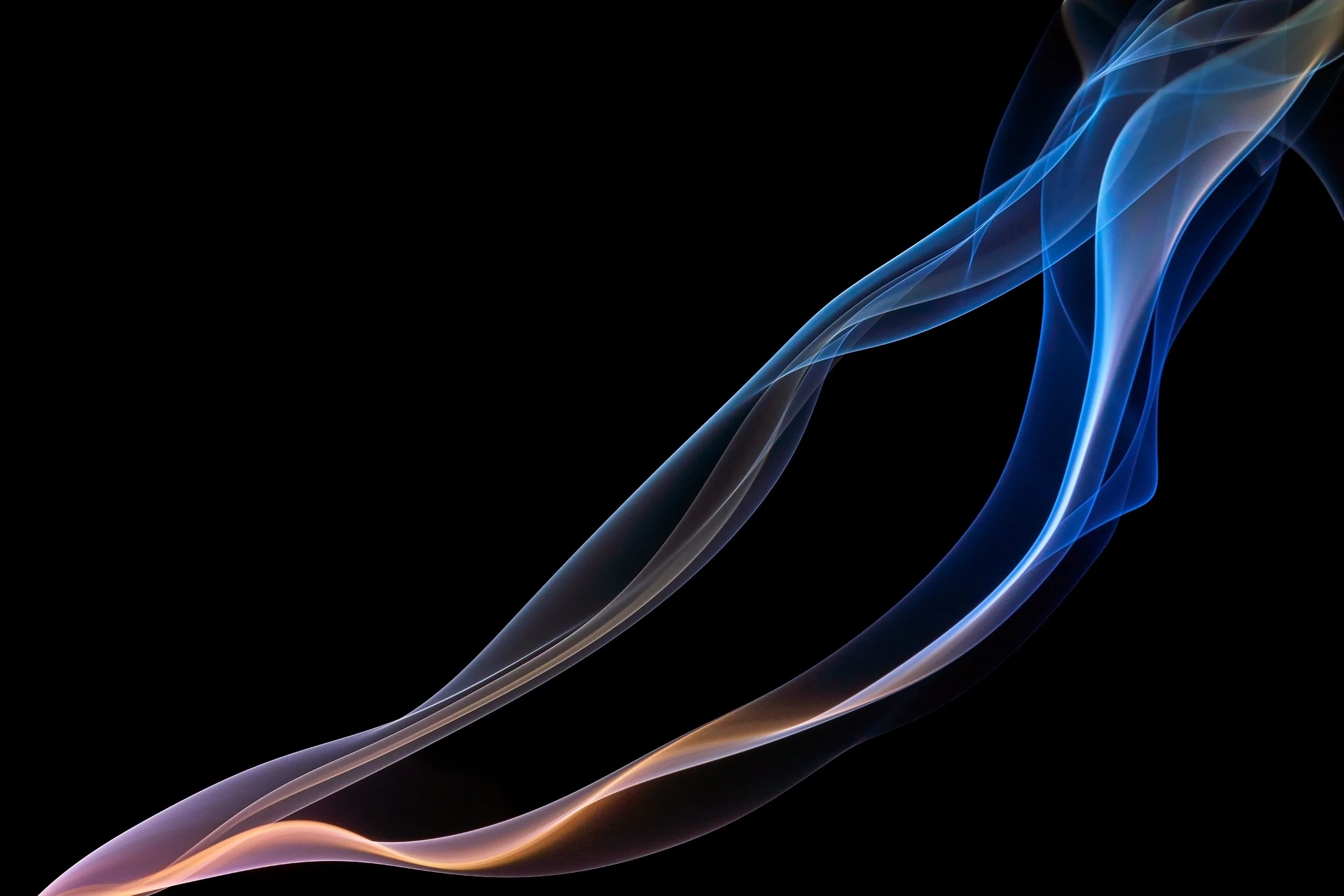 Colorful swirling smoke against a black background.