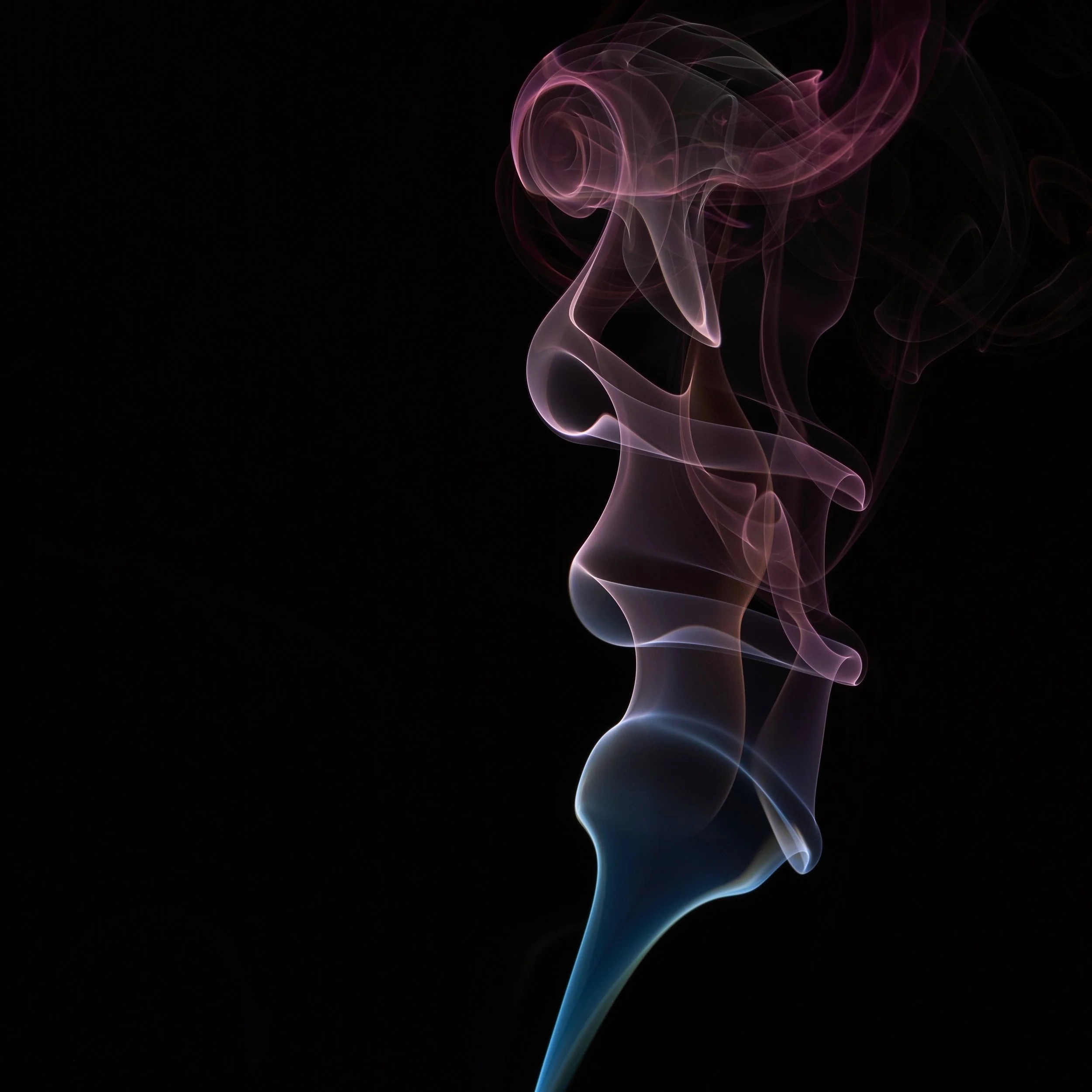 Colorful wisps of smoke in shades of blue, pink, and purple rising against a black background.