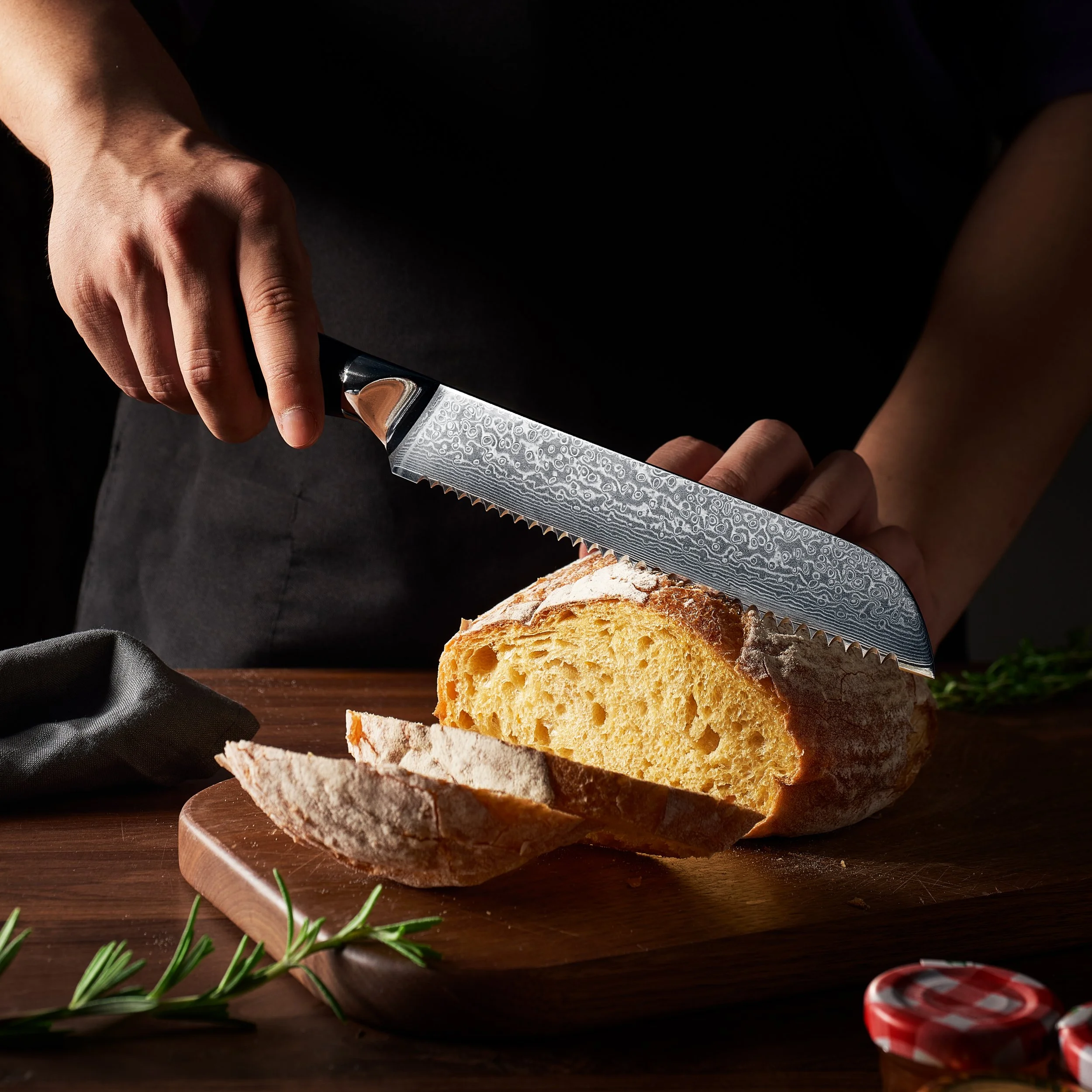 A person slicing a loaf of bread on a wooden cutting board. high-end product photography in China. Kitchen lifestyle photography studio
