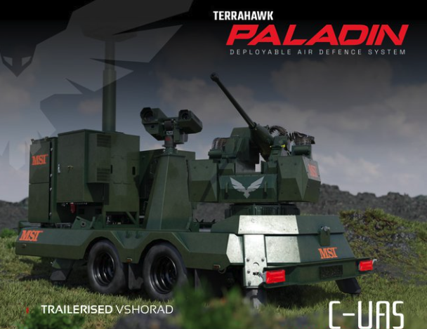 Trailer-mounted Terrahawk Paladin deployable air defense system on a grassy terrain with a cloudy sky background.