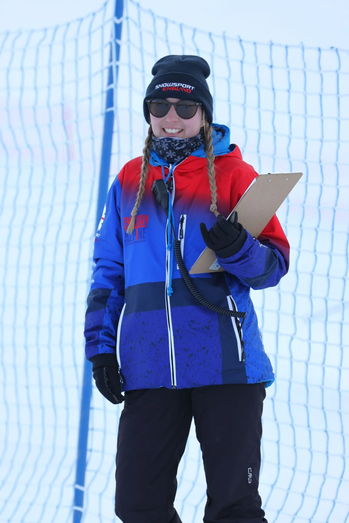 A female volunteer on the snow with a clipboard