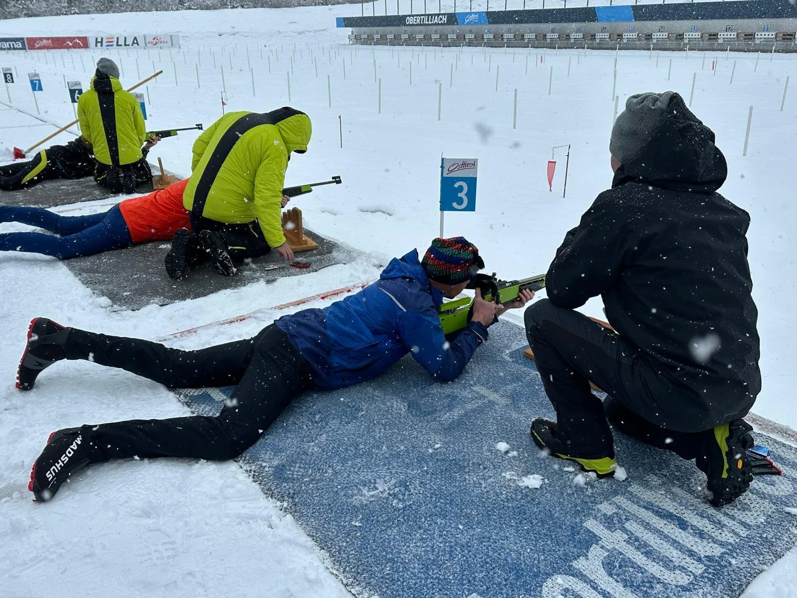 A man lying on the floor in a shooting range in the snow