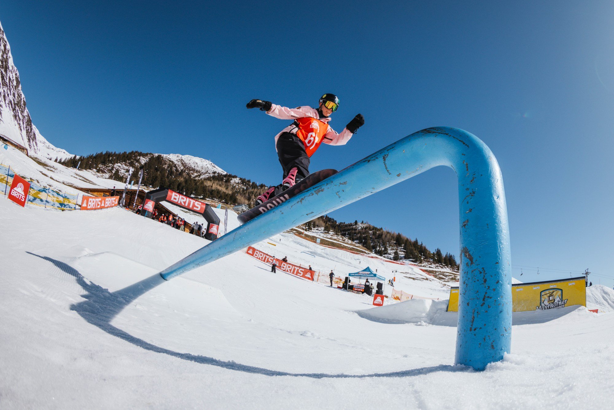 A snowboarder riding a rail at The British Snowboard and Freeski Championships in Austria