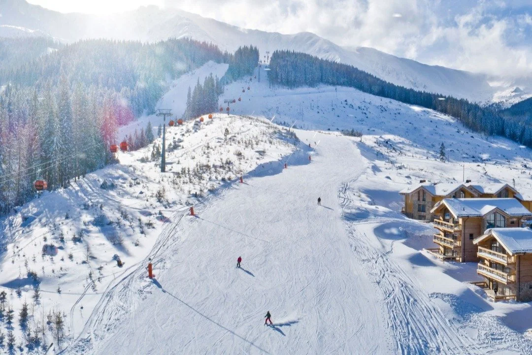 Skiers skiing down a slope in Jasna, Slovakia