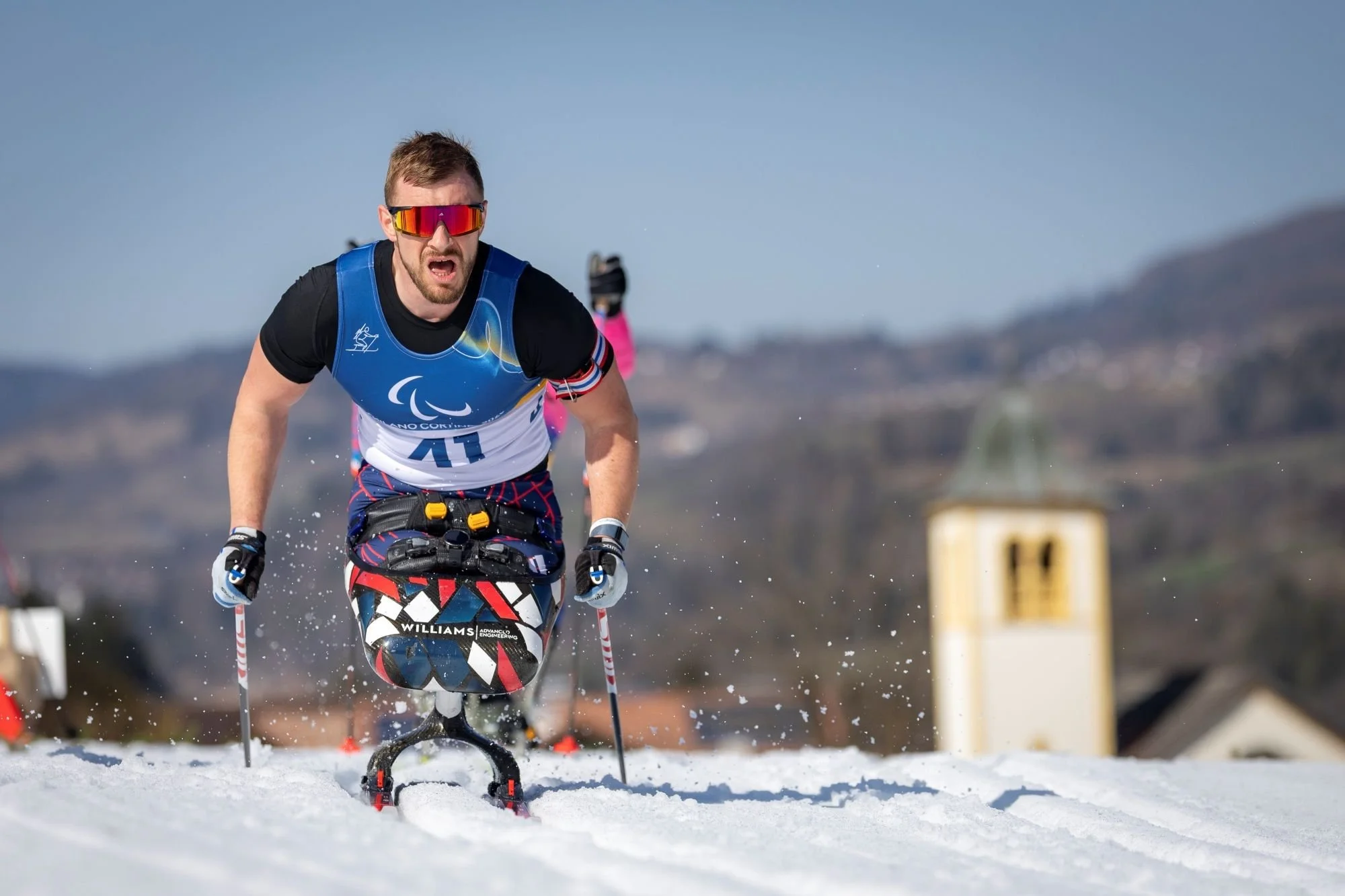 Olympic para nordic skier skiing along a track in the snow