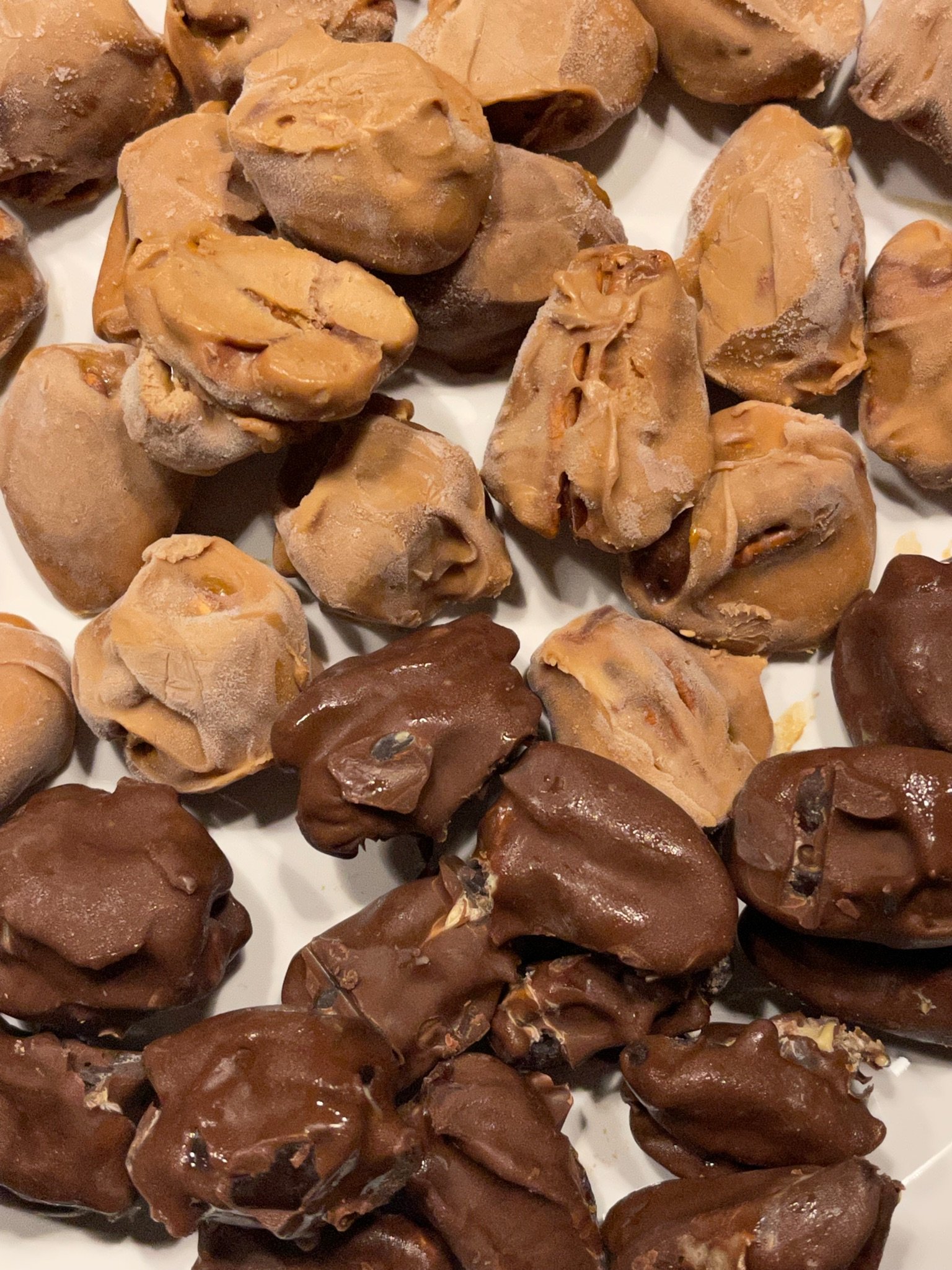 Assorted chocolates and caramel candies with a glossy finish.