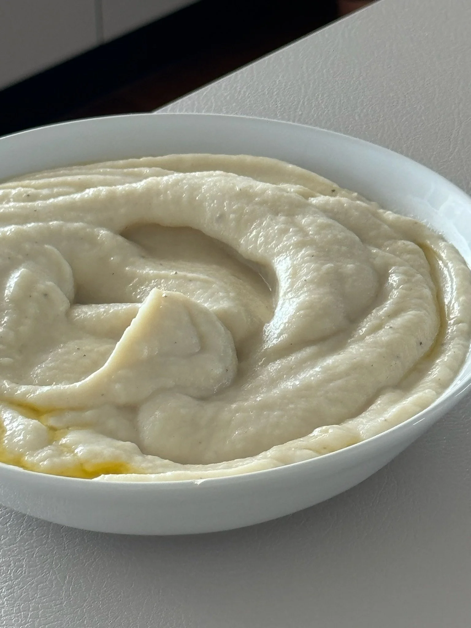 Bowl of mashed potatoes with butter.