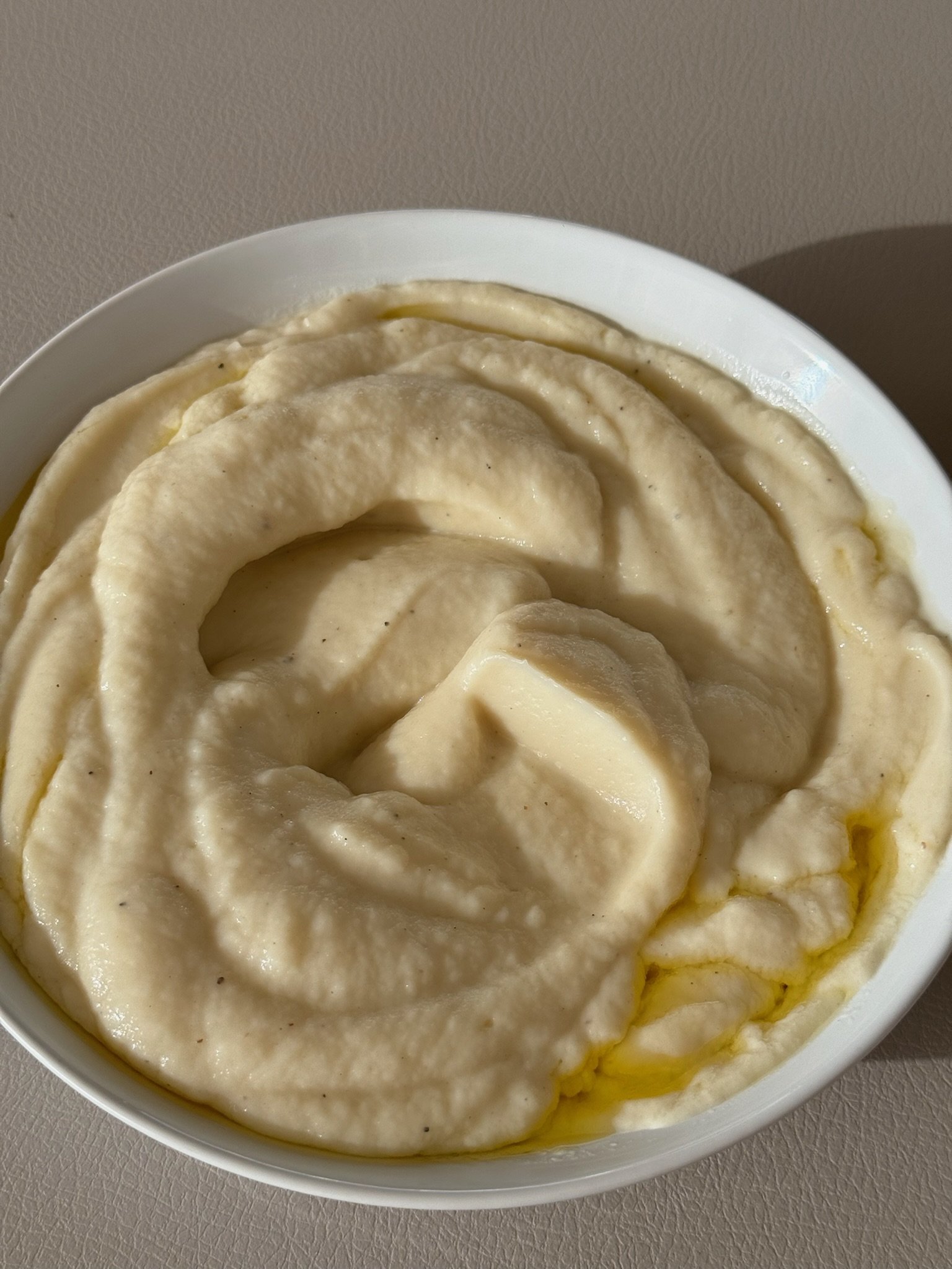 Close-up of a bowl of mashed potatoes with butter