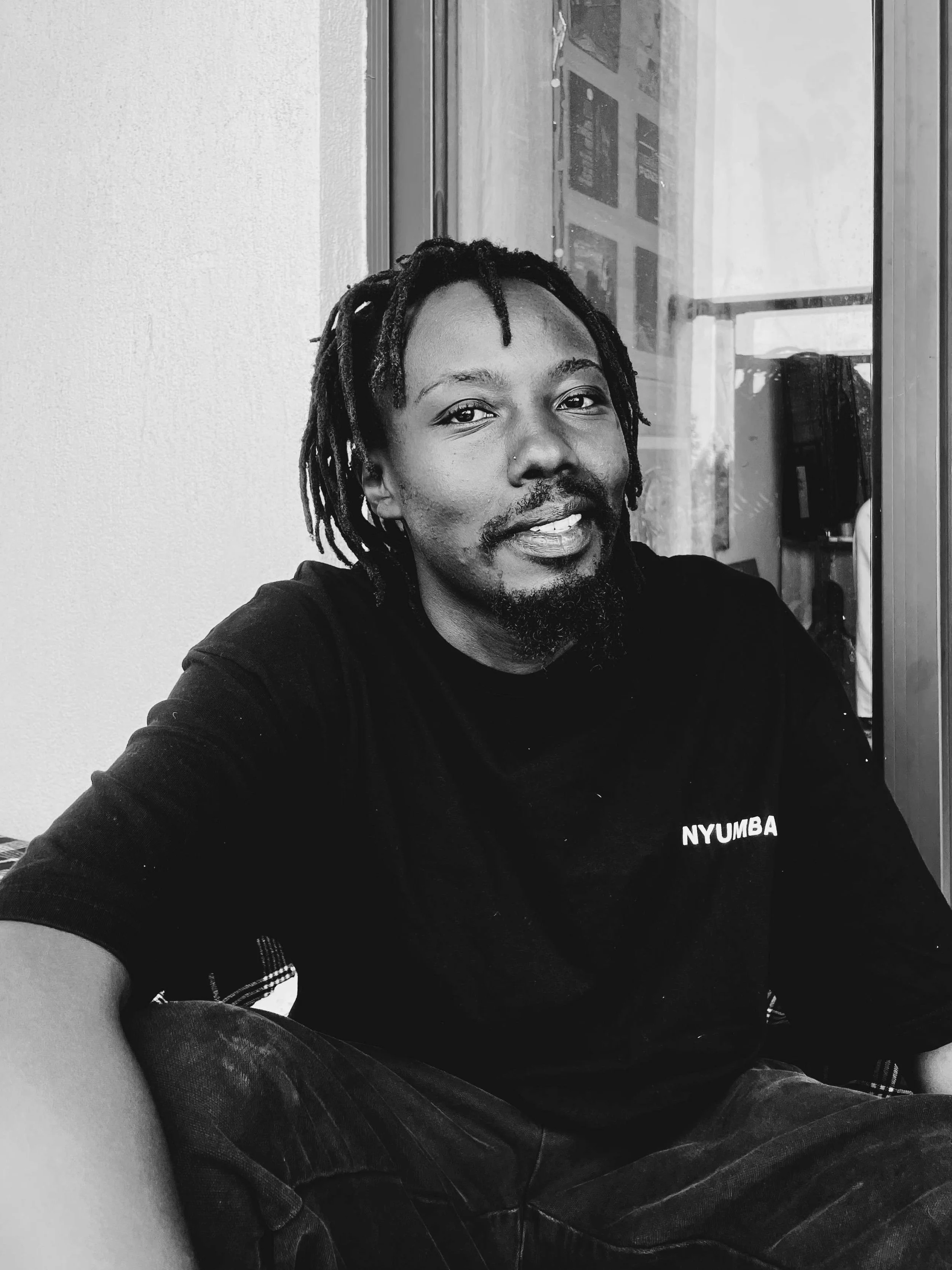 Bethuel Muthee Githegi is a
Nairobi-based poet, curator, and
DJ whose work moves across
language, sound, and visual
culture. His practice explores
imagination as a space for
memory, perception, and social transformation. Through poetry, exhibitions, 