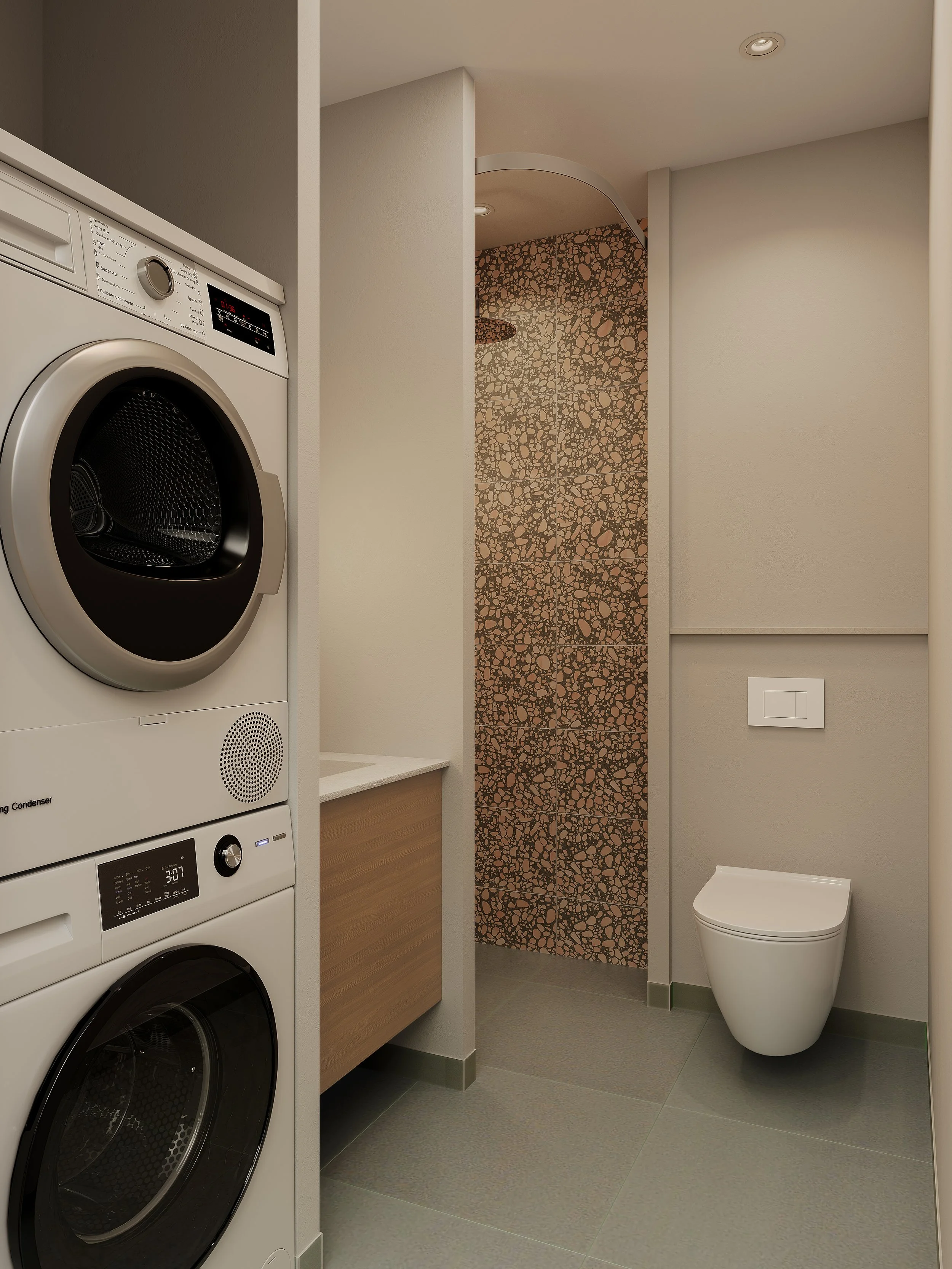 Billede af et vaskerum med vaskemaskine og tørretumbler, en lille vask bærer, og en væg med mosaikfliser, samt en suspenderet toilet.