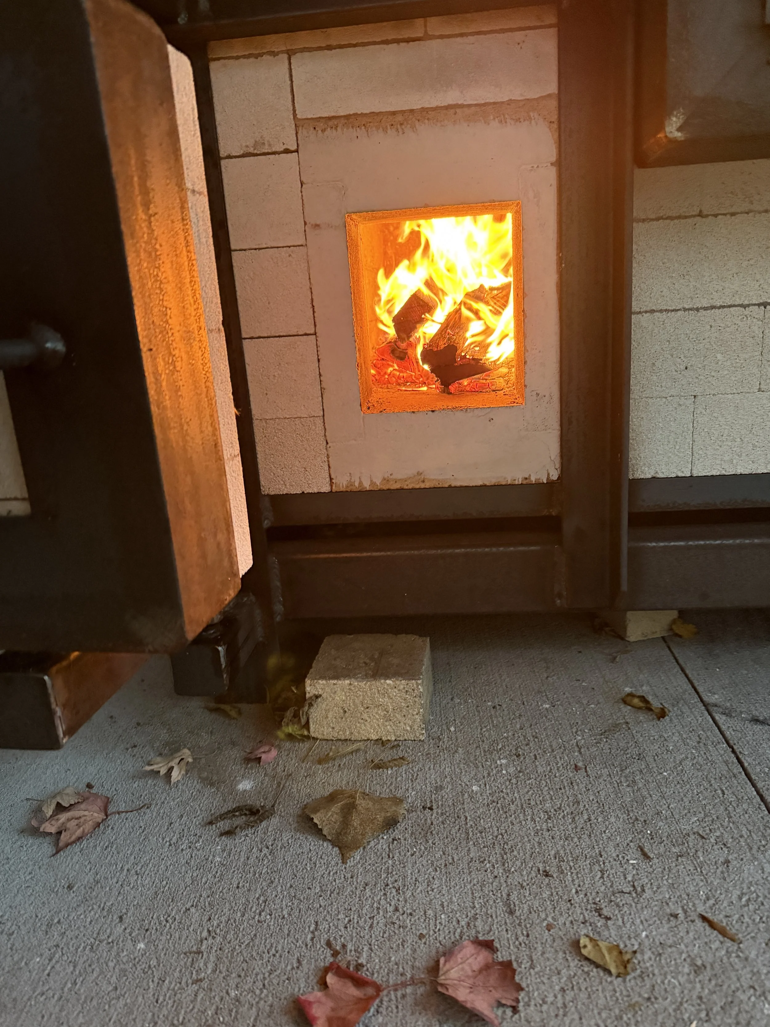 Kiln firebox stoking with red oak
