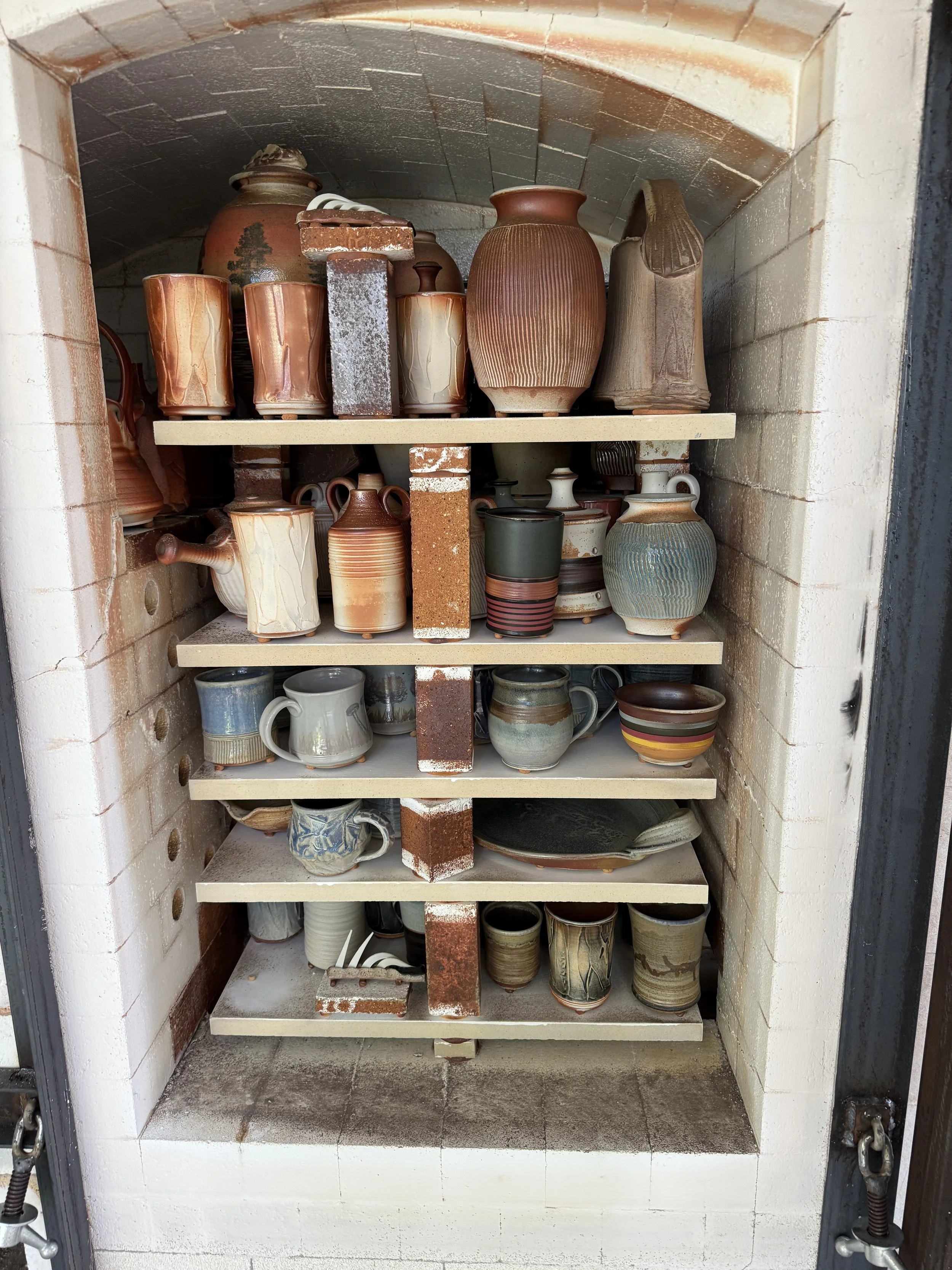 A collection of glazed pottery and ceramic work after cooling from the Wood-Firing.