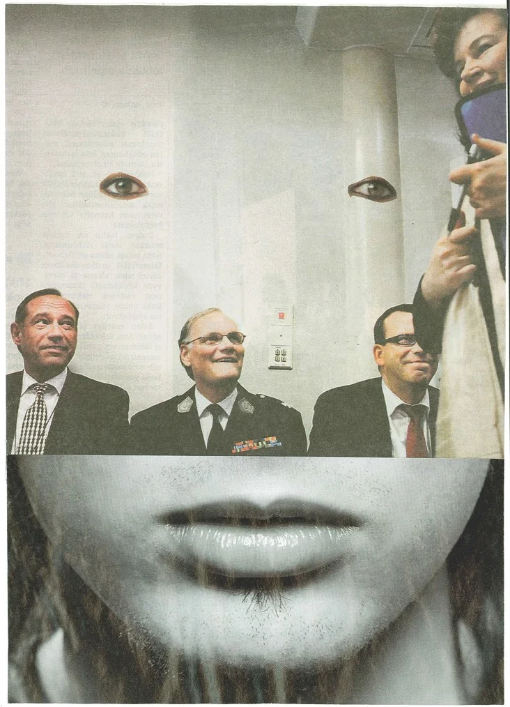A large poster of a woman's face with her eyes and lips visible. The poster features the eyes and mouth of a woman, with three men in suits and glasses seated below, appearing to be part of the woman’s face, creating a surreal visual effect.