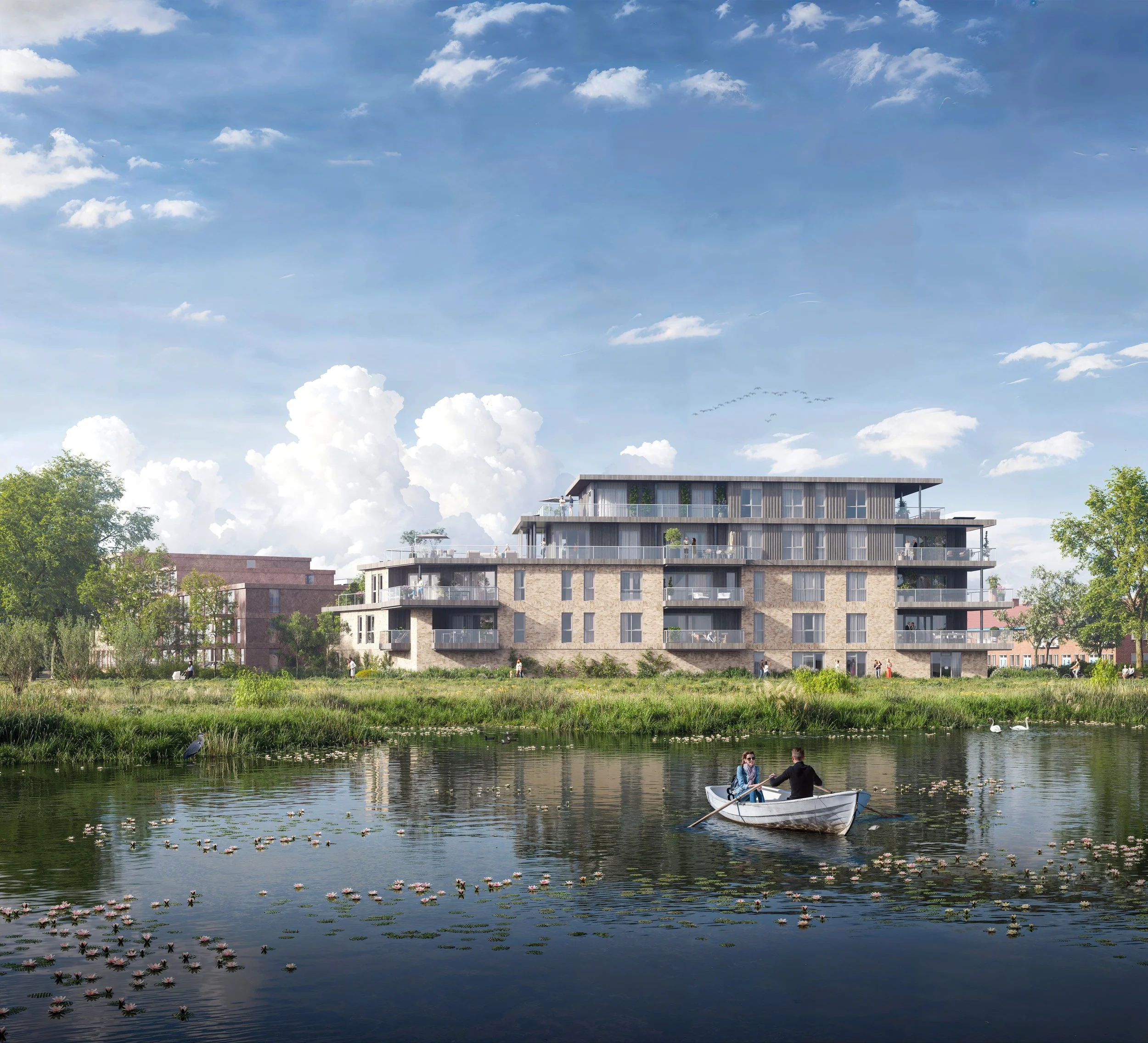 Visserij op een waterarm in de buurt van een modern appartementencomplex met meerdere verdiepingen, omringd door bomen en grasvelden, met een blauwe lucht en witte wolken.