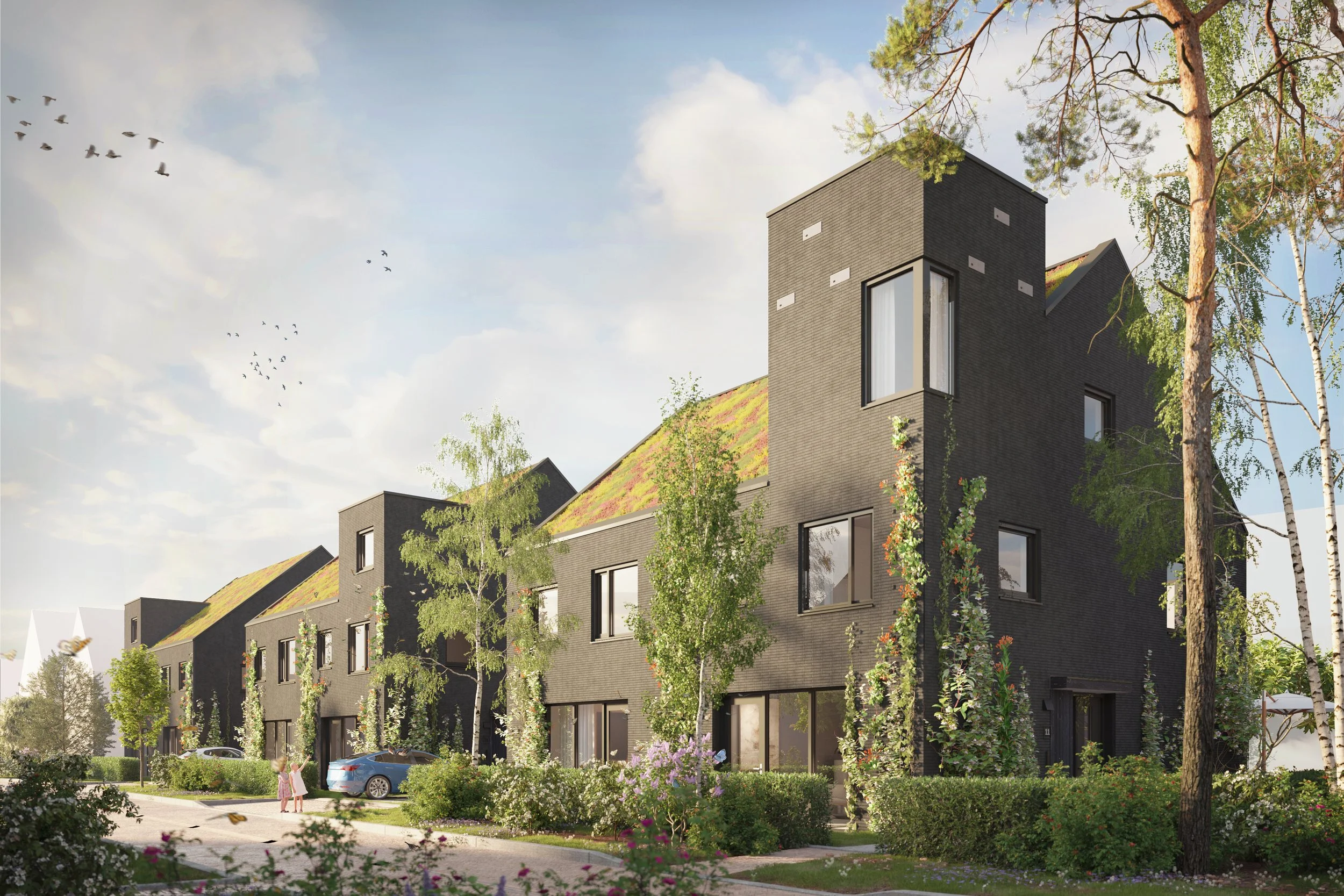 Moderne, zwarte rijtjeshuizen met groene daken, omgeven door bomen en bloemen, met mensen en geparkeerde auto's op de straat.