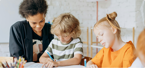 A boy writing with supervision
