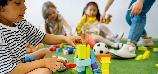 A boy stacking up blocks