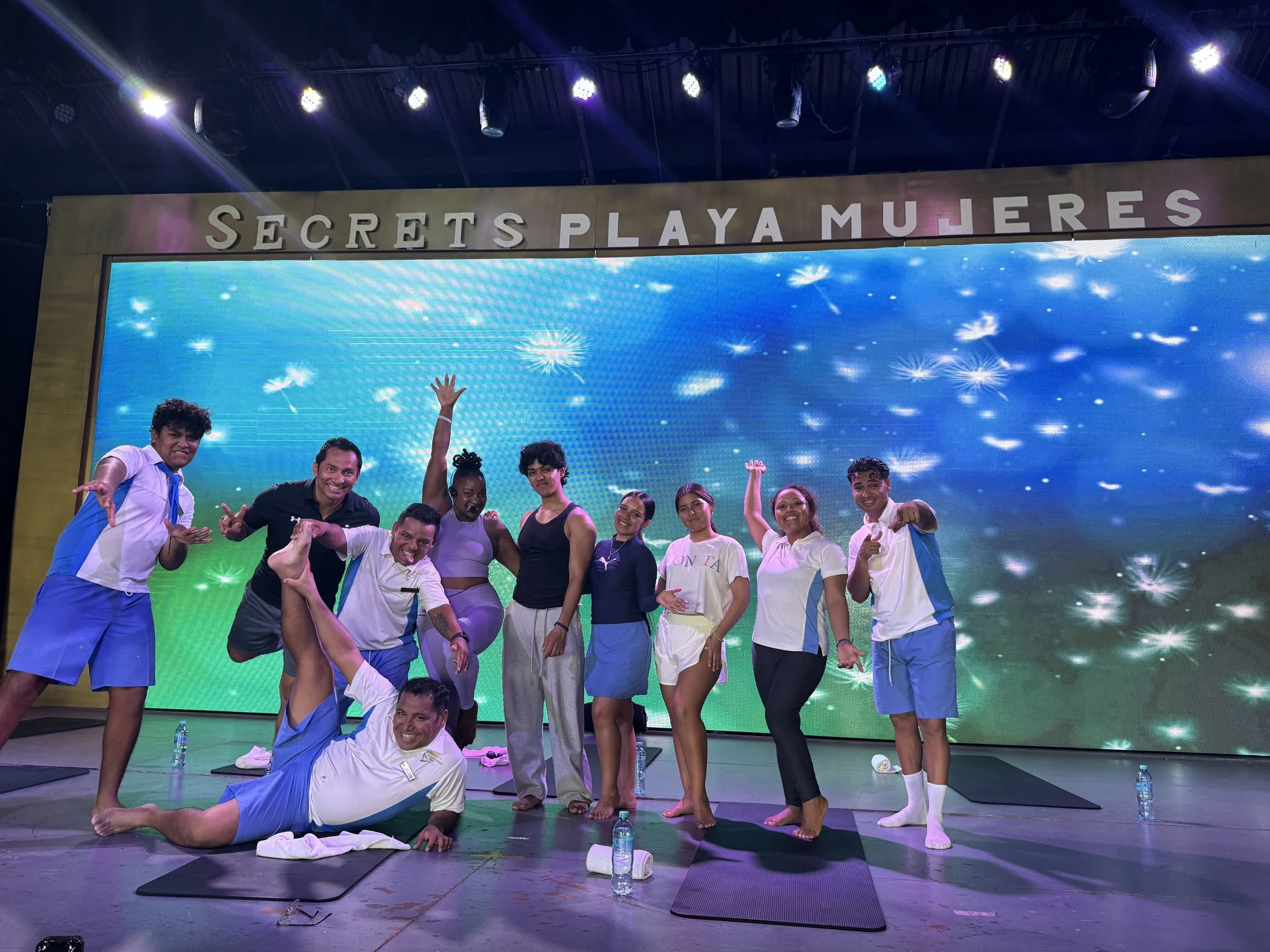 Group participating in a mat Pilates wellness session at Secrets Playa Mujeres