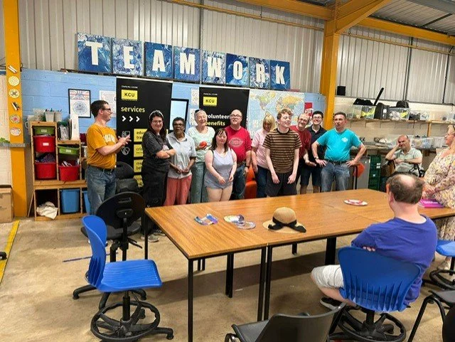 Group of people standing in a room with