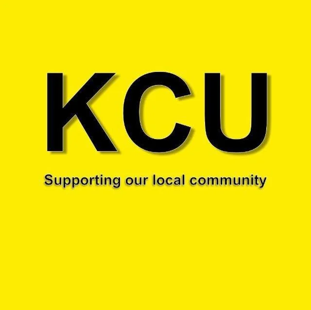 Yellow background with large black letters 'KCU' and smaller black text saying 'Supporting our local community.'