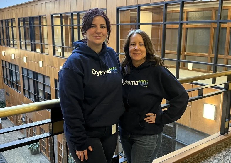 Dykema staff show off Dykema100 swag sweatshirts during the firms centennial kickoff. 
