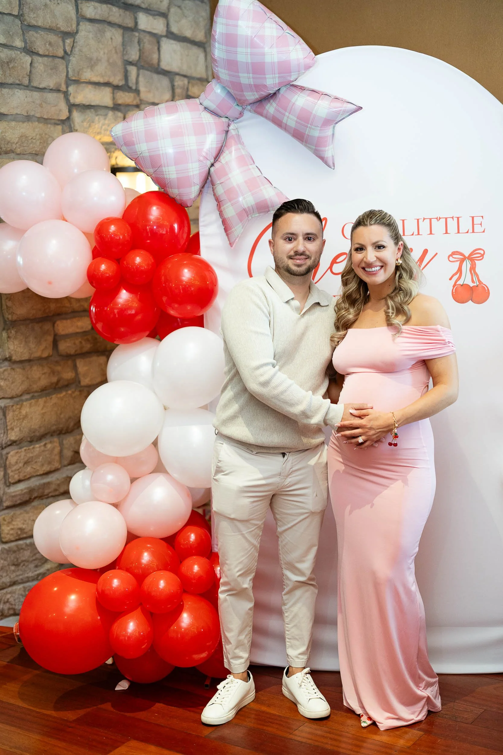a married couple men holding woman pregnant belly 