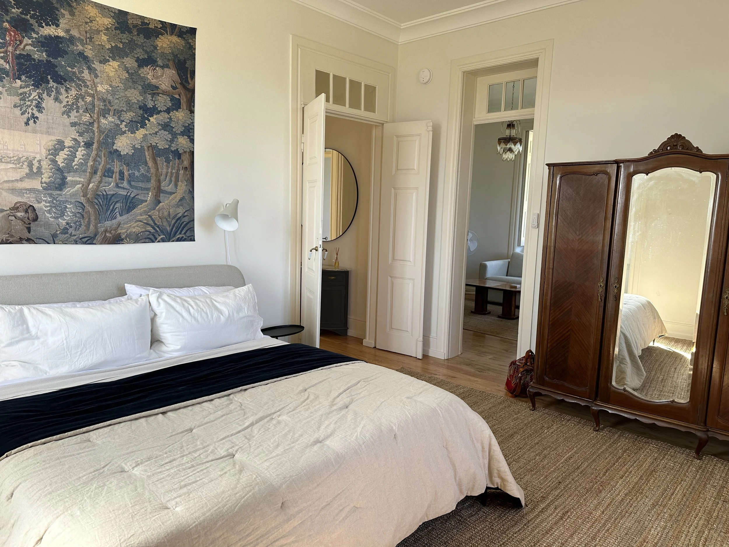 Top-floor bedroom at Casa Belo Horizonte with a king bed and views toward the river and surrounding vineyards.