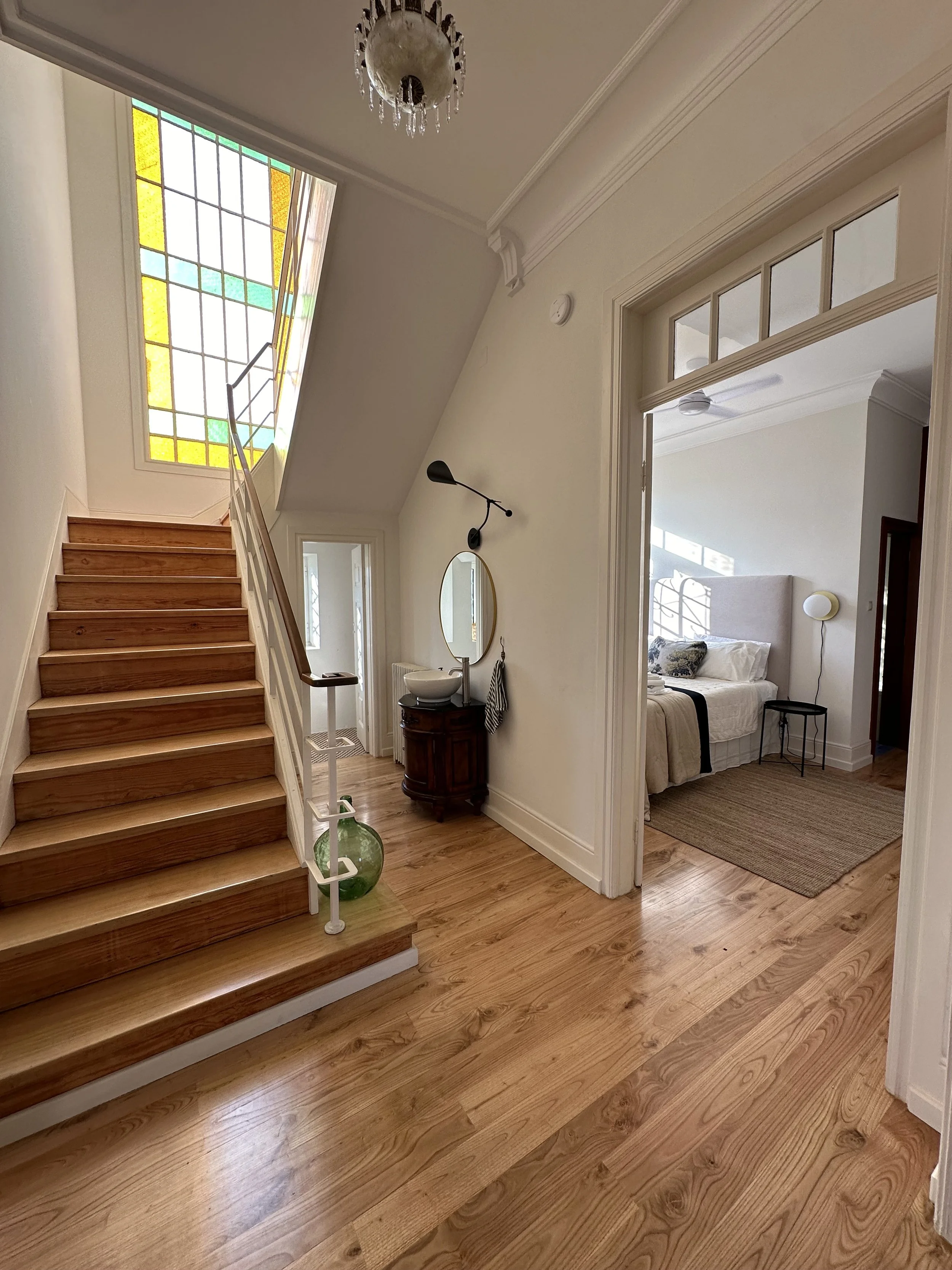 Stained glass window above the stairwell and half bath at Casa Belo Horizonte.