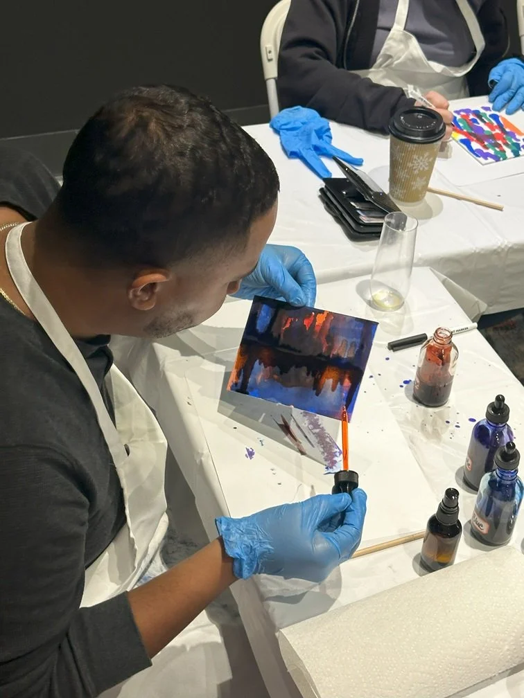 Classroom close up of someone working on an alcohol ink project.