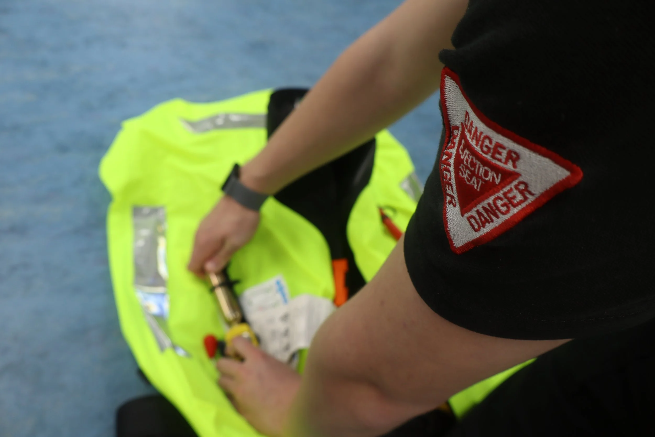 A member of staff servicing a high visibility liferaft.