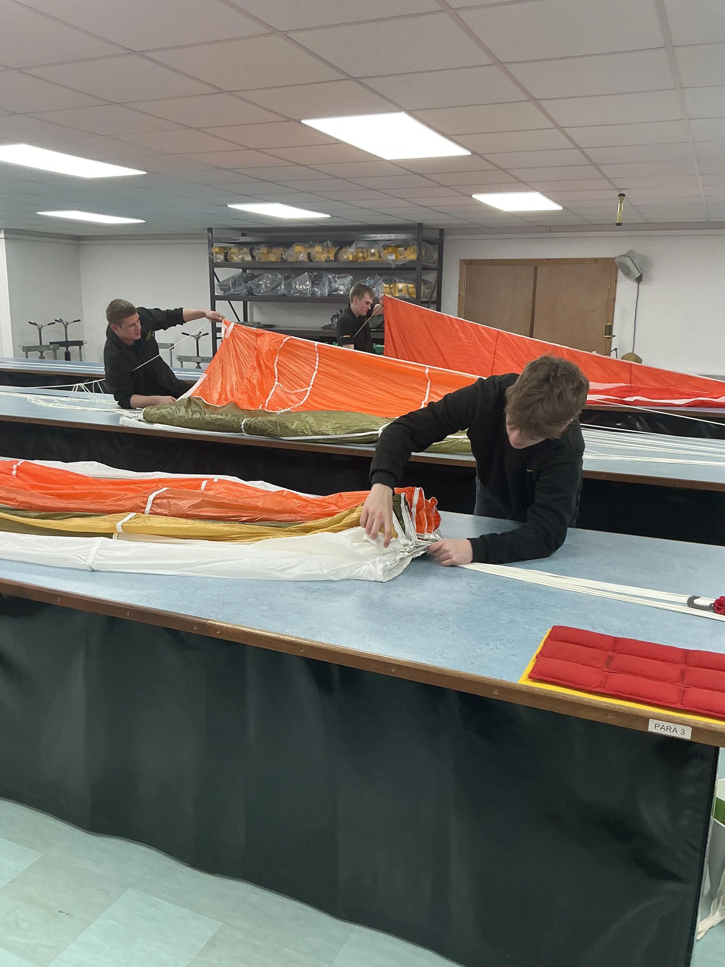 survival equipment technicians packing parachutes
