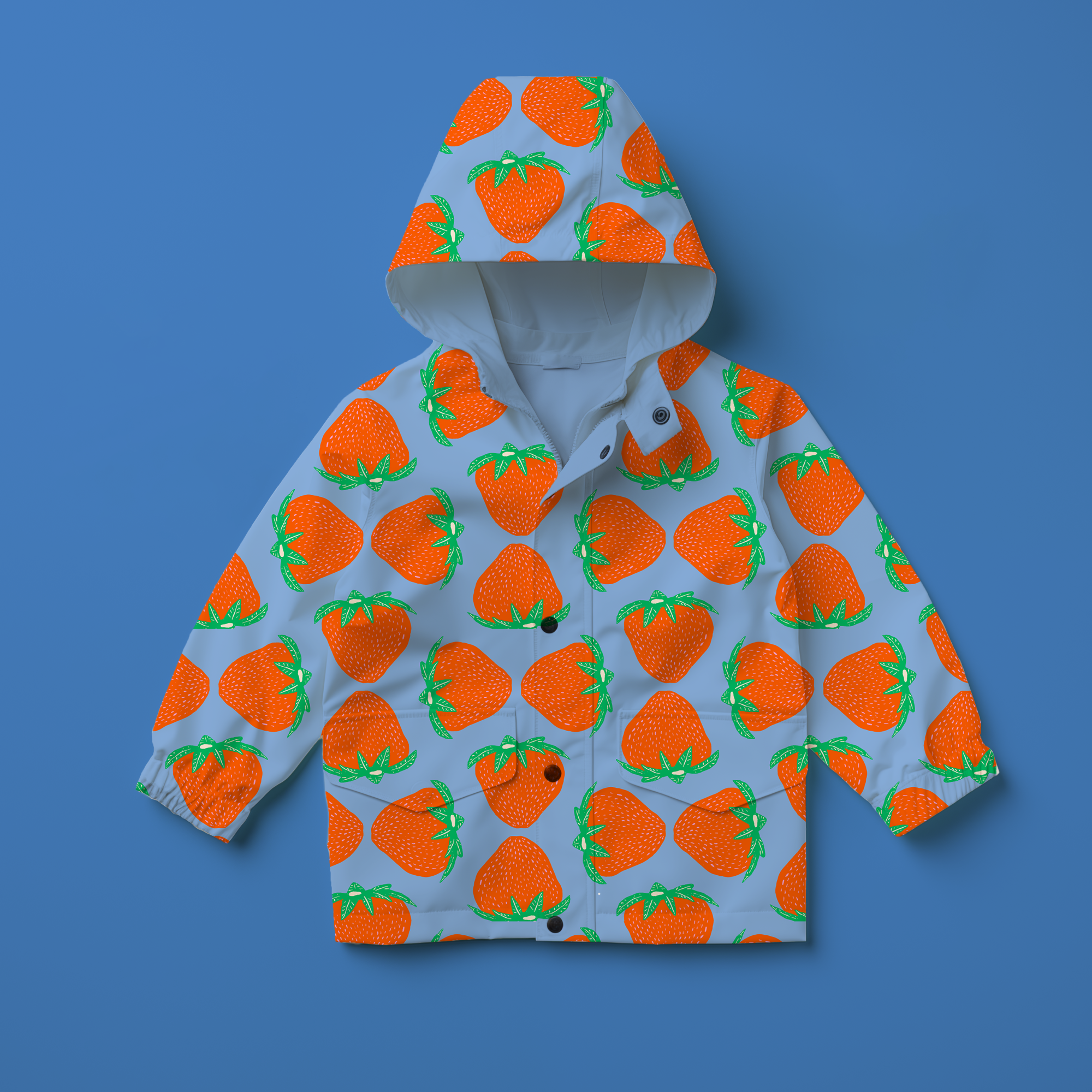 Children's raincoat with a strawberry print pattern on a blue background.
