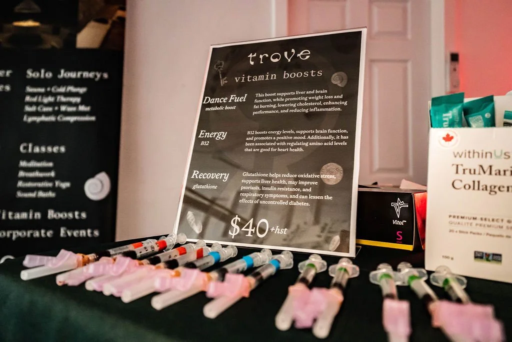 Display of syringes with pink labels and a sign promoting different health shots called Trove, including ingredients and benefits, priced at $40 plus tax.