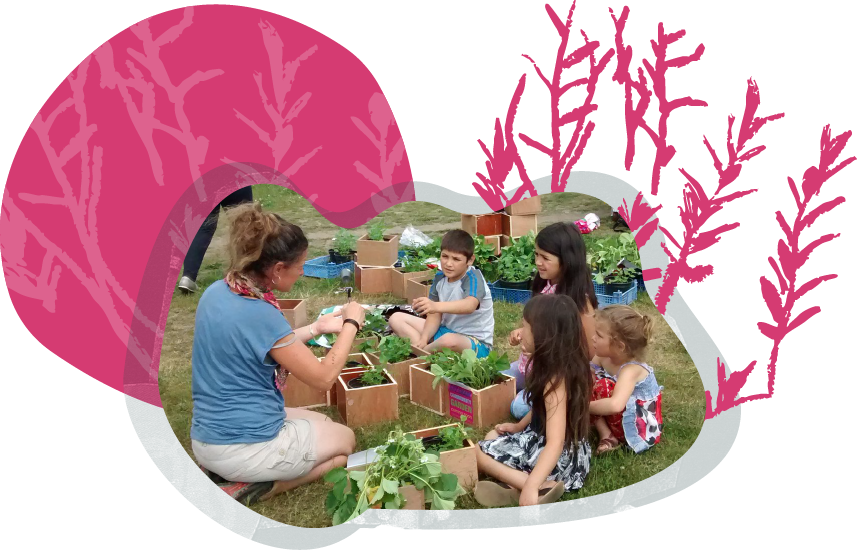 Children sitting on the grass and participating in a gardening activity with an adult, surrounded by plant boxes filled with green plants.