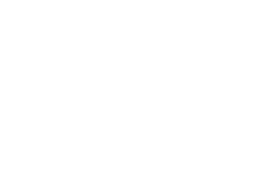 Silhouette of a person climbing a steep rock face.