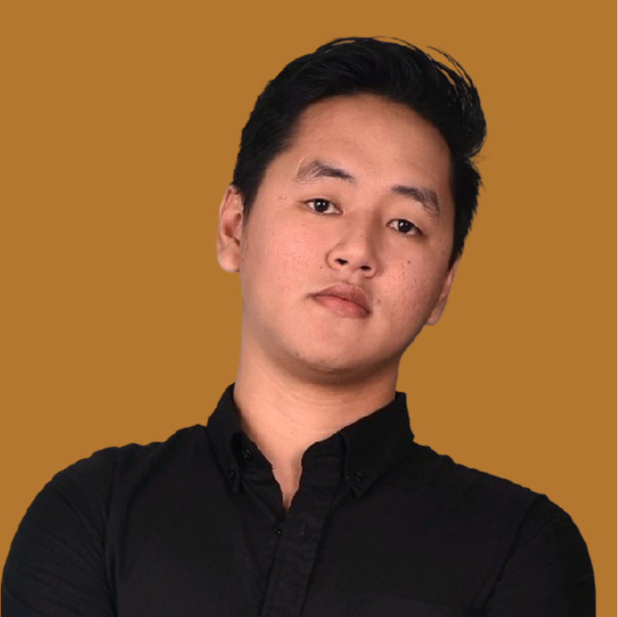 A young man with black hair wearing a black collared shirt, posing with a neutral expression against a brown background.