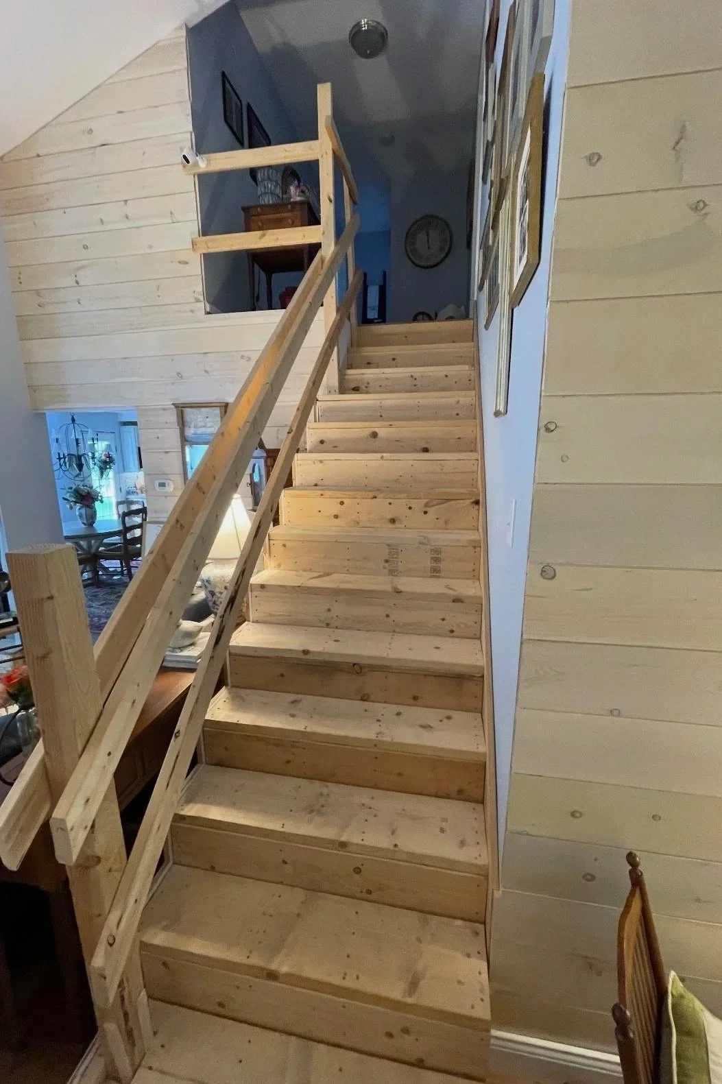 Before: Framed stairs with plywood treads and temporary safety rail.
