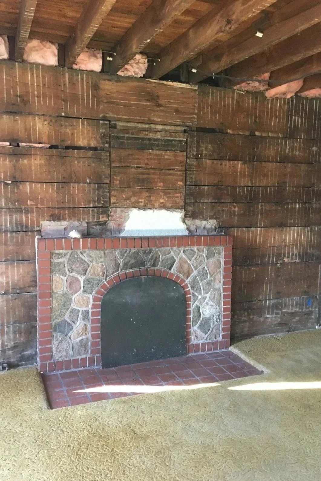 Before: Removed fireplace exposing lathe and brick with unfinished hearth.
