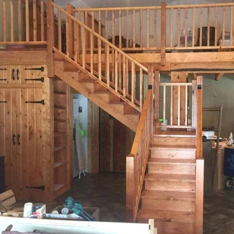 After: Finished staircase with integrated railing, loft landing, and built-in storage.
