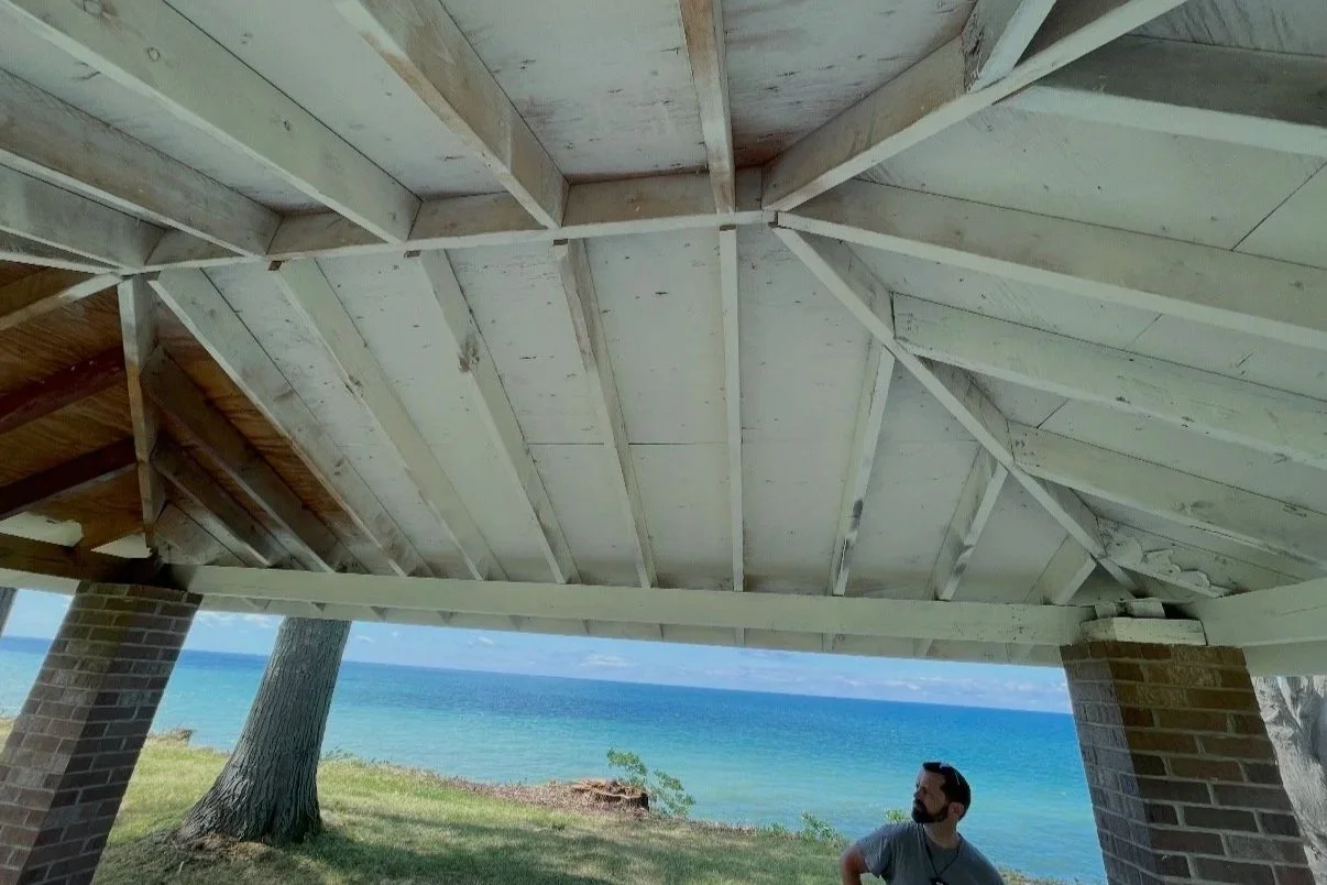 Before: Exposed rafters and peeling wood ceiling over porch.