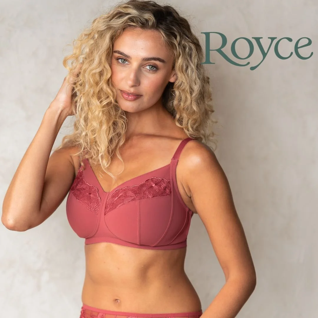 A woman with curly blonde hair wearing a pink bra with lace details. The background has the text "Royce" in green.