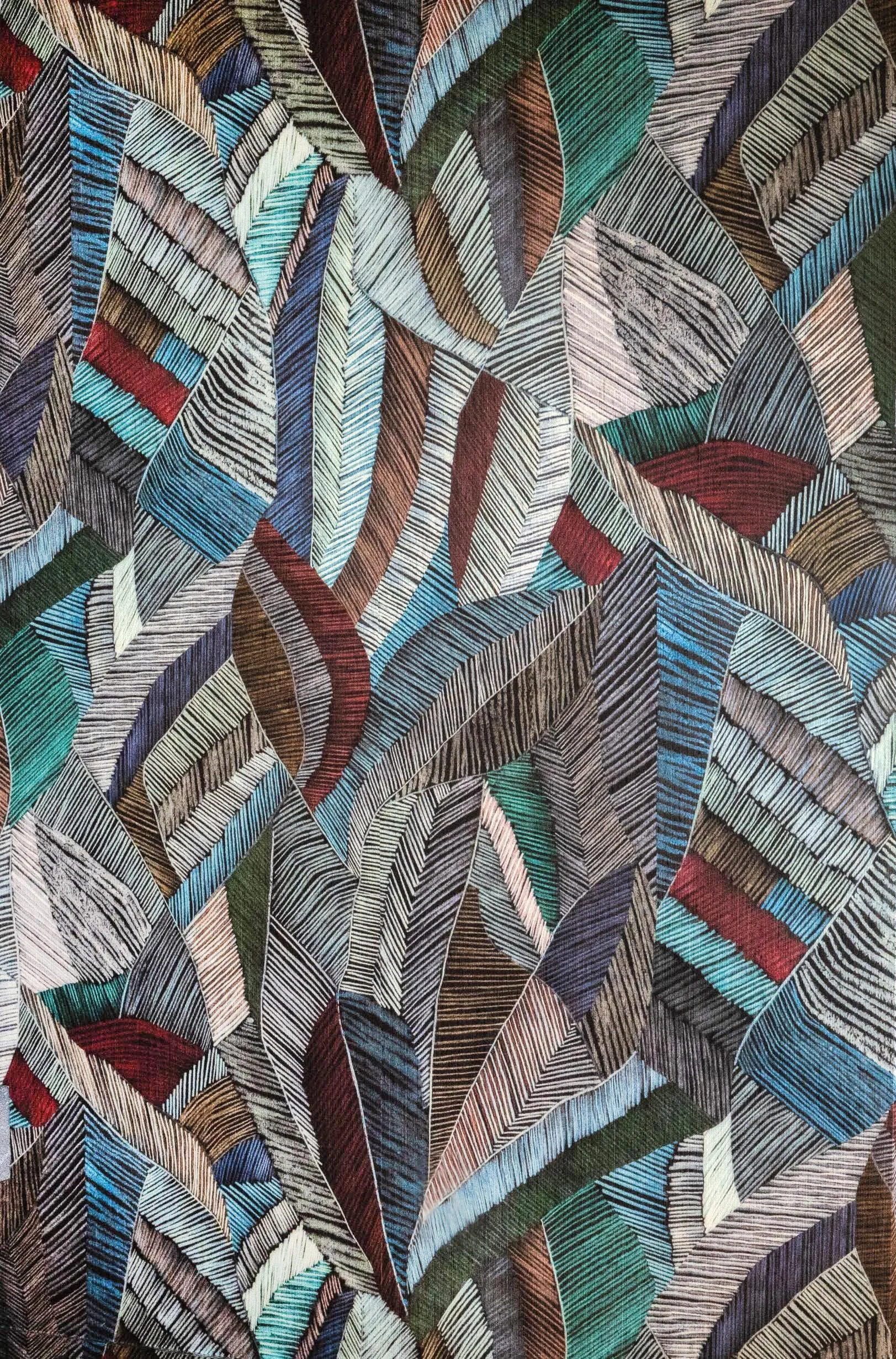 Close-up of colorful, geometric pattern wallpaper featuring leaf designs with lines and various earthy colors like brown, green, blue, red, black, and beige.