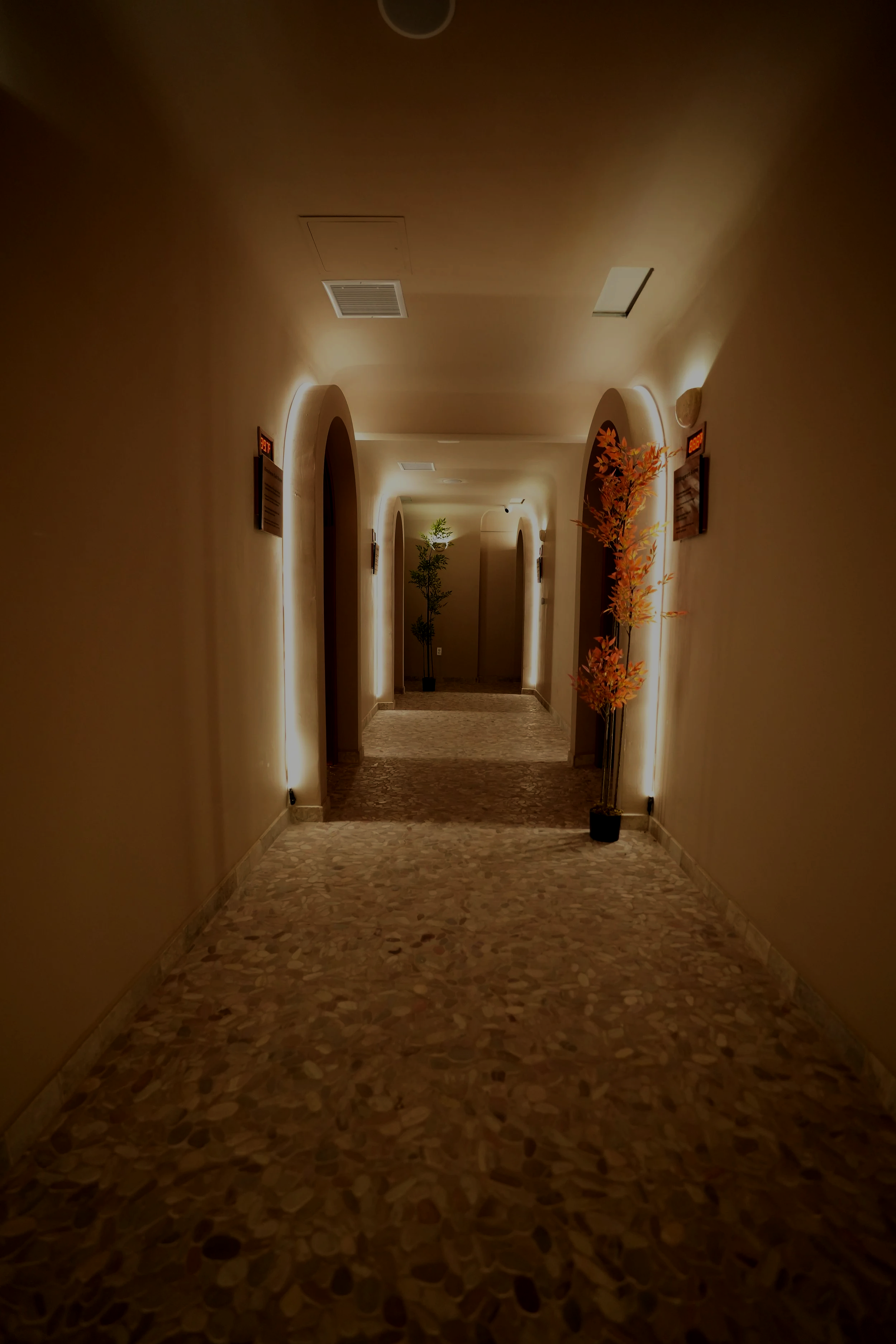 Hallway to the healing rooms at Karma Wellness in San Diego offering therapeutic massage, red light therapy, salt therapy, cryotherapy, relaxation, recovery, and wellness treatments.