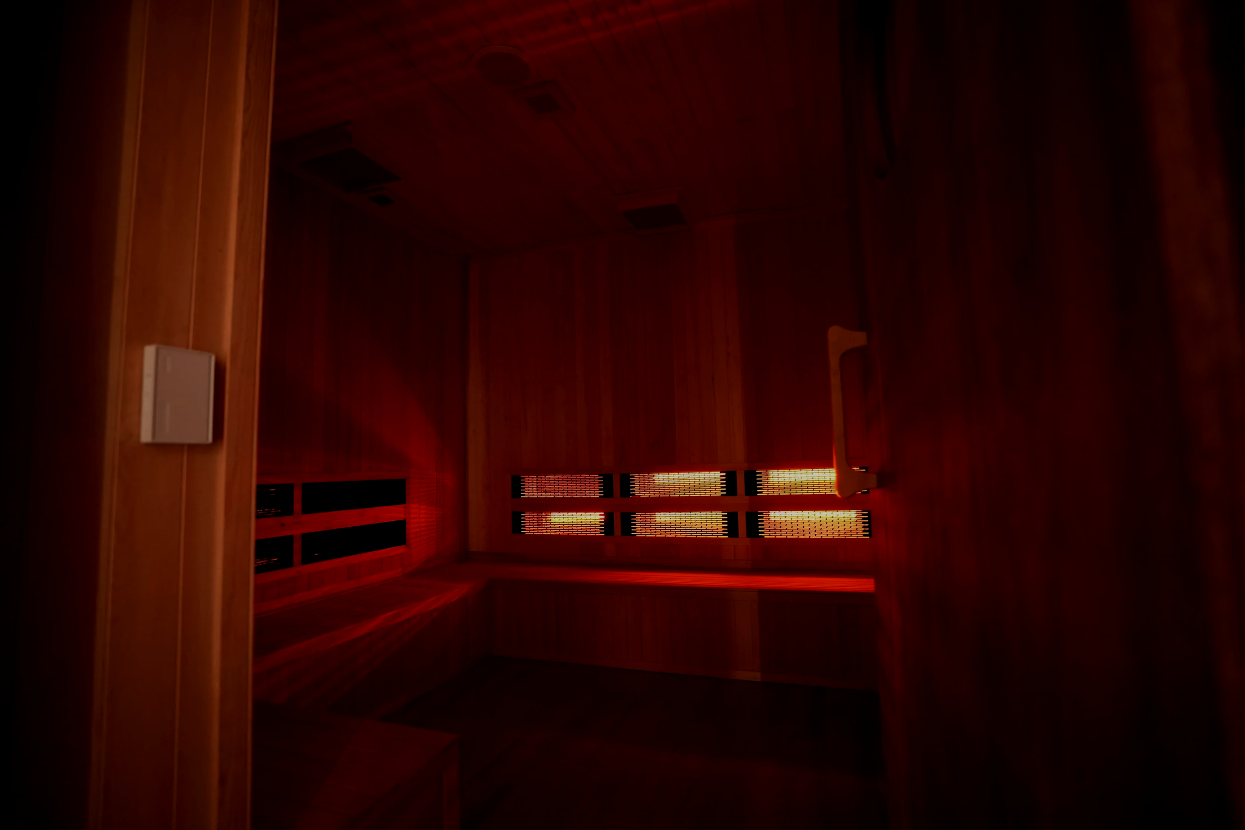 Infrared red light therapy room at Karma Wellness in San Diego designed to support relaxation, recovery, circulation, muscle recovery, and nervous system regulation through calming heat and therapeutic light exposure.