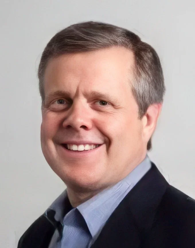 Kent Weaver, Advisor at Hudson Street Ventures. Headshot of a smiling man with short brown hair, wearing a dark blazer and light blue collared shirt, against a plain light background.