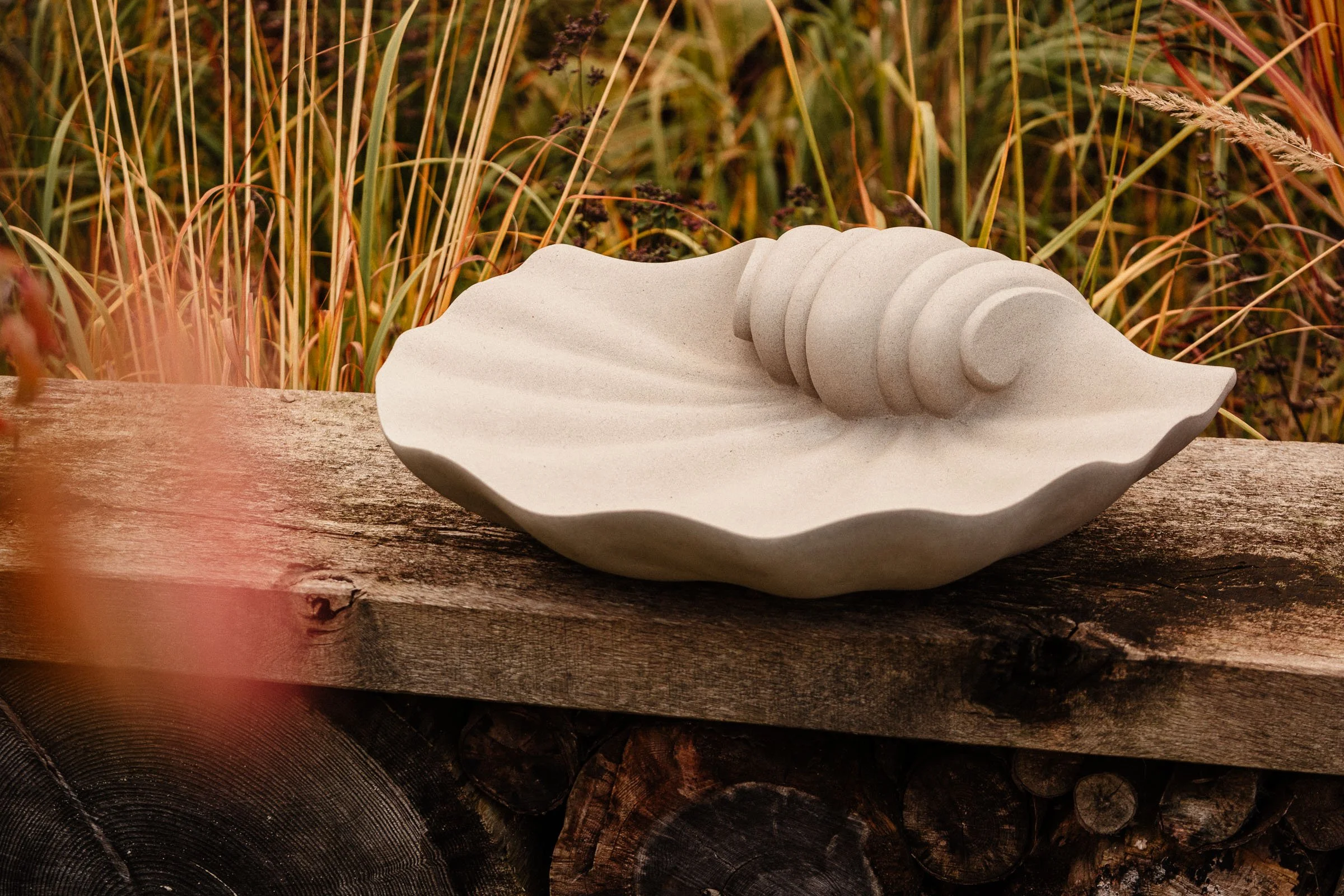 Natural stone, shell-shaped birdbath